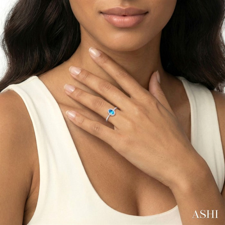 5X3 MM Oval Shape Blue Topaz and 1/20 Ctw Round Cut Diamond Halo Semi-Precious Ring in 10K White Gold