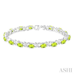 7x5  MM Oval Cut Peridot and 1/20 Ctw Round Cut Diamond Fashion Bracelet in Sterling Silver