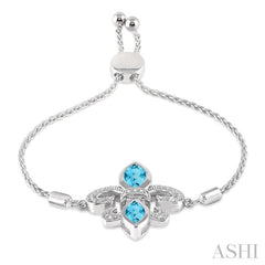 1/20 Ctw Round Diamond and Marquise 10x5 MM & 8x4 MM Blue Topaz Fleur De Lis Sterling Silver Lariat Bracelet